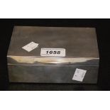 A George V silver cigarette box, engine turned decoration, vacant cartouche, 9cm x 14cm,