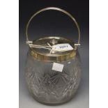 A cut glass biscuit barrel with plated mounts