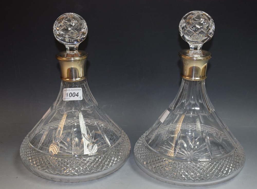 A pair of cut glass ship's decanters, globular stoppers, silver collars, Birmingham 1994,
