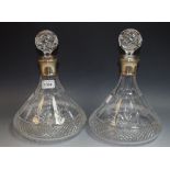 A pair of cut glass ship's decanters, globular stoppers, silver collars, Birmingham 1994,