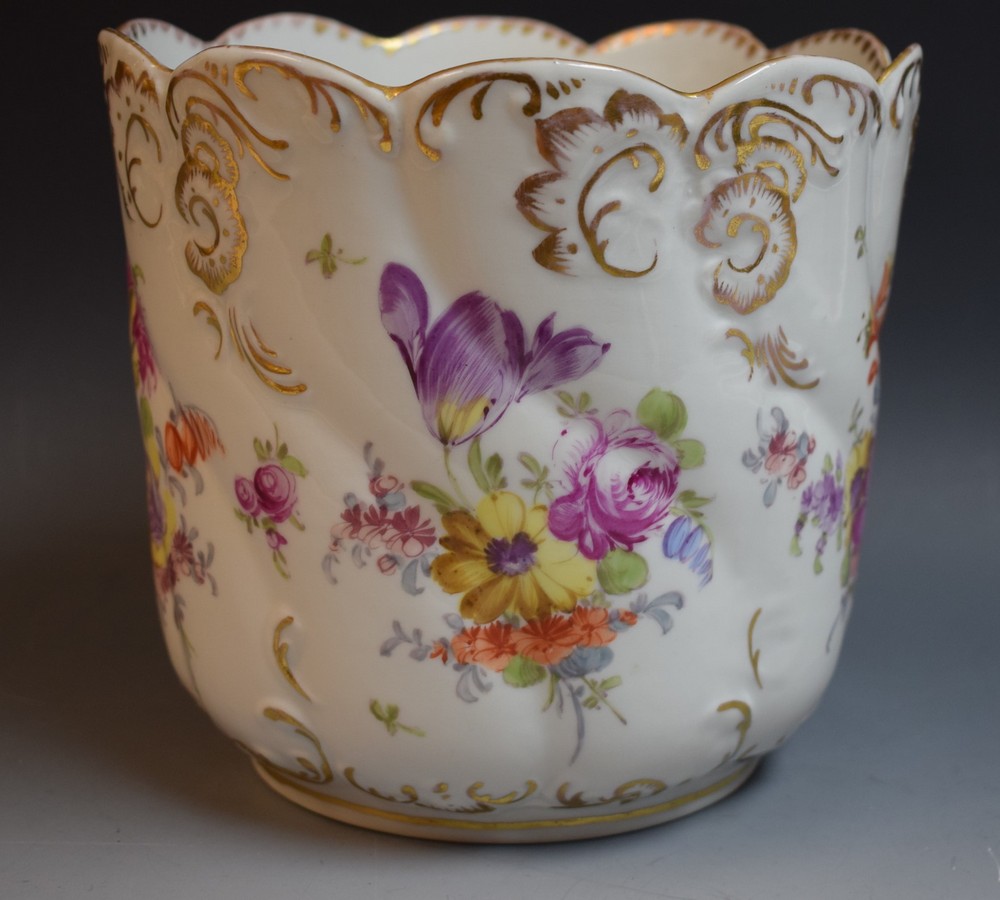 An early 20th century Dresden spirally fluted jardiniere hand painted with Deutsche Blumen,