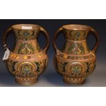 A pair of Sarreguemines art nouveau pottery twin handled vases,