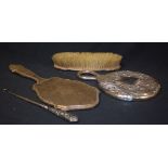 Silver - a silver backed clothes brush; a similar hand mirror; a silver hafted boot hook;