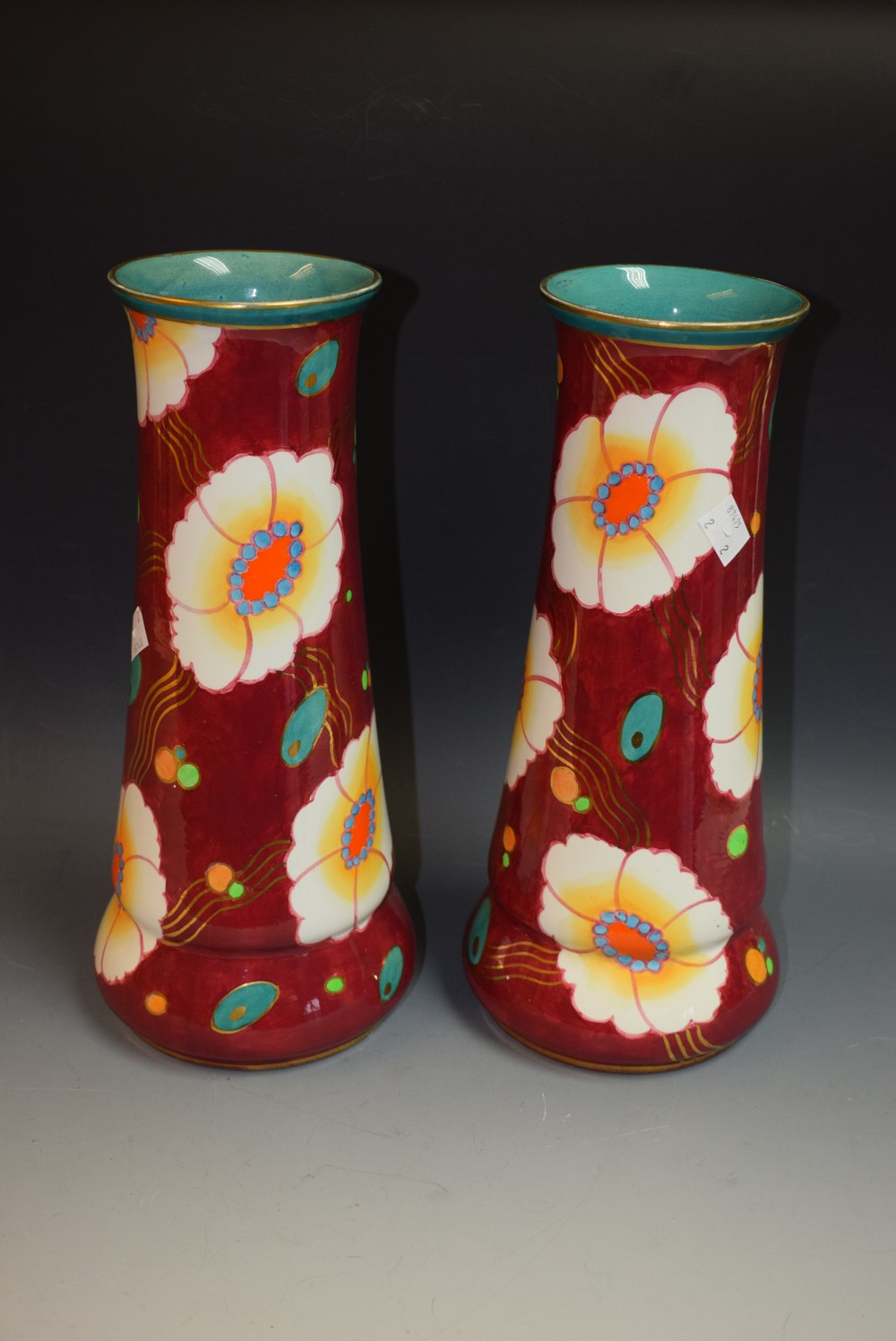 A pair of Losol ware vases, floral decoration on burgundy ground, turquoise interior,