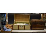 A miniature doll's travel trunk containing doll's clothes, straw hat,