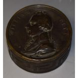 A 19th century brass circular snuff box,