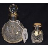 A cut glass scent bottle, silver rim,