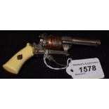 A pin fire six barrel purse revolver with folding trigger and chased foliate decoration