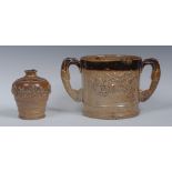 A Brampton brown salt glazed stoneware two-handled loving cup, applied with fruit,