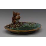 A George Jones majolica Squirrel nut dish, moulded with squirrel holding an acorn,