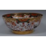 A Spode wash bowl, decorated in the Imari palette with stylised bamboo, fence and foliage,