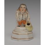 A Staffordshire Jolly Toper pen holder, of a rotund gentleman, wearing a gilt lined jacket,