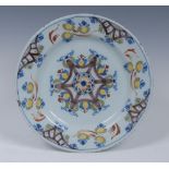 An 18th century Delft plate, decorated in manganese, blue and green, 22.5cm diam, c.