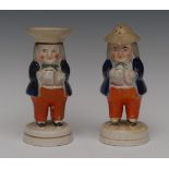 A pair Staffordshire Jolly Toper pepper and salt pots, they stands holding a mugs of foaming ale,