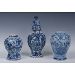 A Delft panelled baluster jar, painted in tones of blue and white with flowers and stylised leaves,