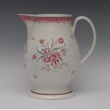 A large creamware jug, inscribed in red Success to Trade, the sides with peonies and flowerheads,