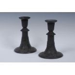 A pair of Wedgwood black basalt candlesticks, bell shaped sconces,