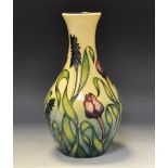 A contemporary Moorcroft ovoid bottle vase, designed by Nicola Slaney, tube lined with tulips,