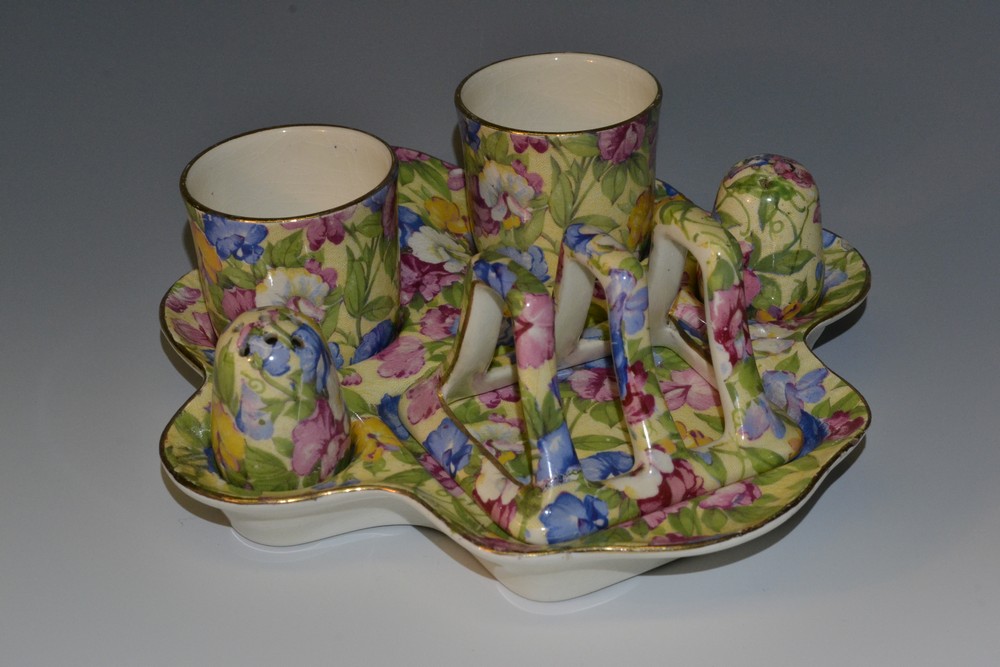 A Royal Winton Sweet Pea pattern breakfast set, comprising two egg cups, salt and pepper pots,