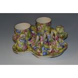 A Royal Winton Sweet Pea pattern breakfast set, comprising two egg cups, salt and pepper pots,