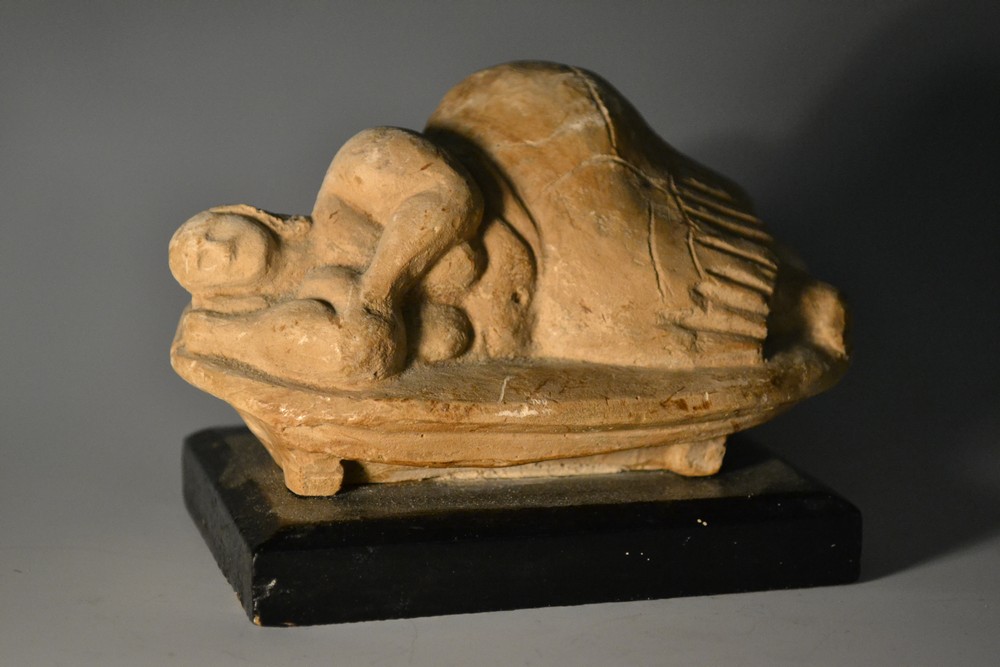 A Studio Pottery naieve clay model of a reclining female, in sandy tones, 12cm wide,