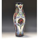 A contemporary Moorcroft slender ovoid vase, tube lined with stylised peacock feathers,