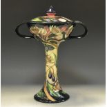 A contemporary Moorcroft Poisettia pattern two handled vase and cover, designed by Emma Bossons,