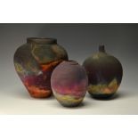 A Studio Pottery globular Raku vase, overall in merging colours on a terracotta ground, 19.