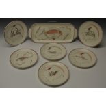 A Poole service, comprising rounded rectangular serving dish and six circular plates,