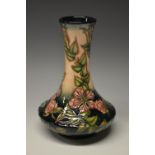 A contemporary Moorcroft Sweet Briar pattern compressed baluster bottle vase,