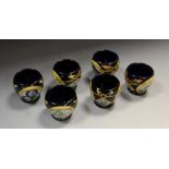 A contemporary set of six Moorcroft egg cups, each designed by Sian Leeper,