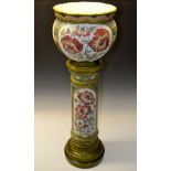 A Burmantoft's Faience jardiniere on stand, moulded with panels of poppies, the jardiniere 28cm,