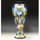 A contemporary Moorcroft Trial Meconopsis pattern slender baluster vase, designed by Rachel Bishop,
