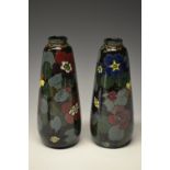 A pair of Decoro tapering cylindrical terracotta vases,