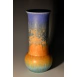 A Ruskin matt crystalline cylindrical bottle vase, drip glazed in merging bands of blue,
