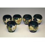 A contemporary set of six Moorcroft egg cups, each designed by Sian Leeper,