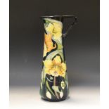 A contemporary Moorcroft Artic Gold jug, designed by Rachel Bishop, with stylised daffodils,