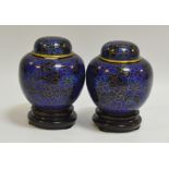 A pair of miniature clossione ginger jars and covers, decorated with black and blue flowers,