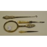 A Victorian silver hafted button hook; a similar magnifying glass;