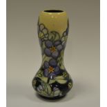 A contemporary Moorcroft waisted vase, tube lined with violets and foliage, 16cm high,
