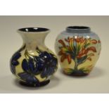 A contemporary Moorcroft ovoid vase, tube lined with large blue flowerheads and mountains, 9cm high,