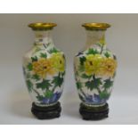 A pair of cloissone enamel baluster vases, decorated with flowers and birds, white ground,