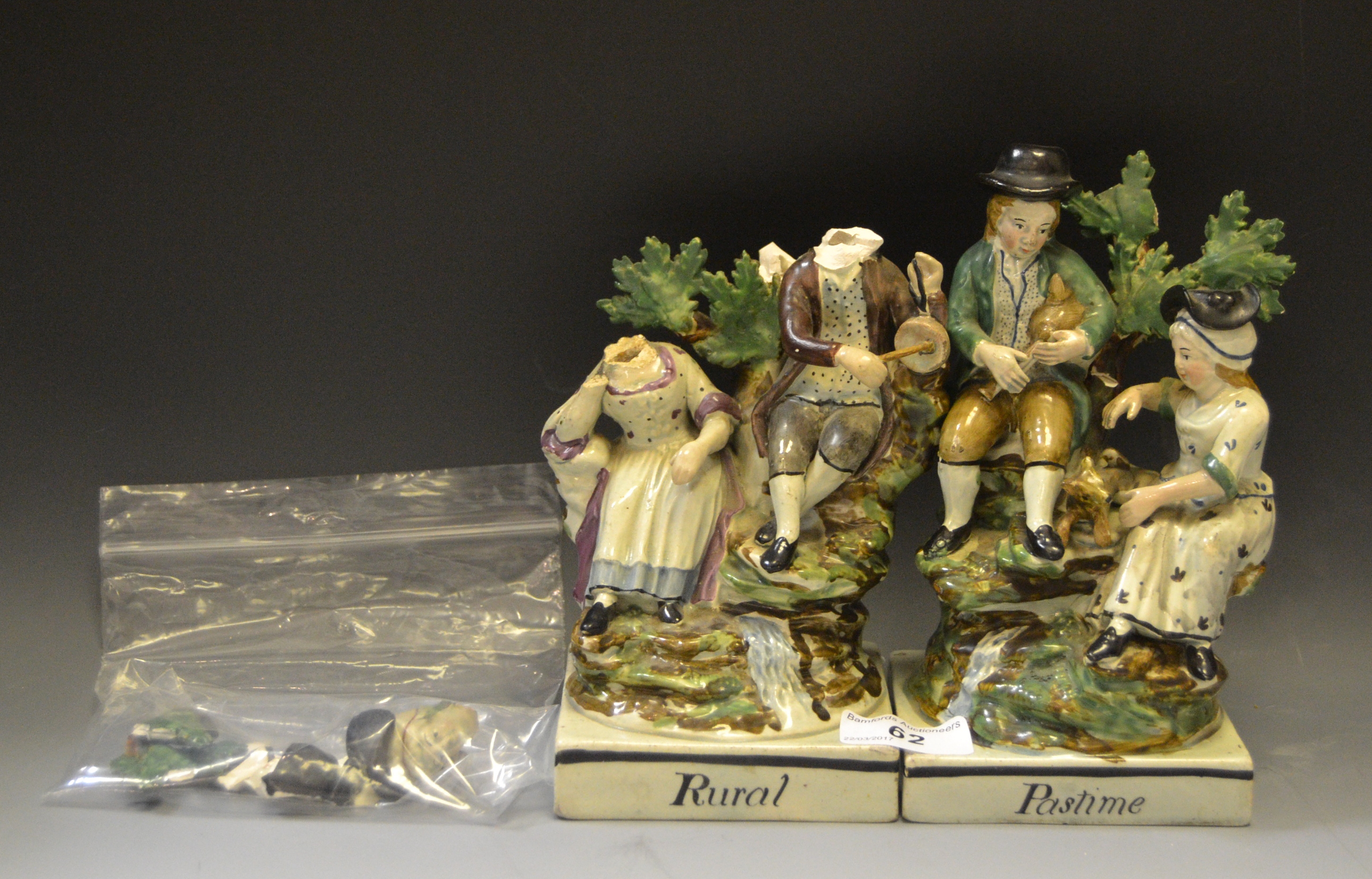 A pair of Staffordshire figural groups, Rural and Pastime, in colours, titled square bases, 18.