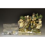A pair of Staffordshire figural groups, Rural and Pastime, in colours, titled square bases, 18.