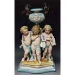 A Continental porcelain group, three cherubs,