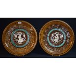 A pair of Clément Massier wall plaque chargers,
