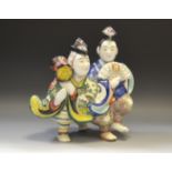 Oriental Ceramics - an Oriental figural group of an elderly gentleman and his spouse