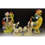 A pair of Staffordshire figures, standing by oversize sheep, gilt line bases, c.