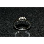 A diamond three stone ring, linear set with three graduated round cut diamonds, total 0.