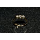 A diamond trilogy ring, three linear set round old brilliant cut diamonds,